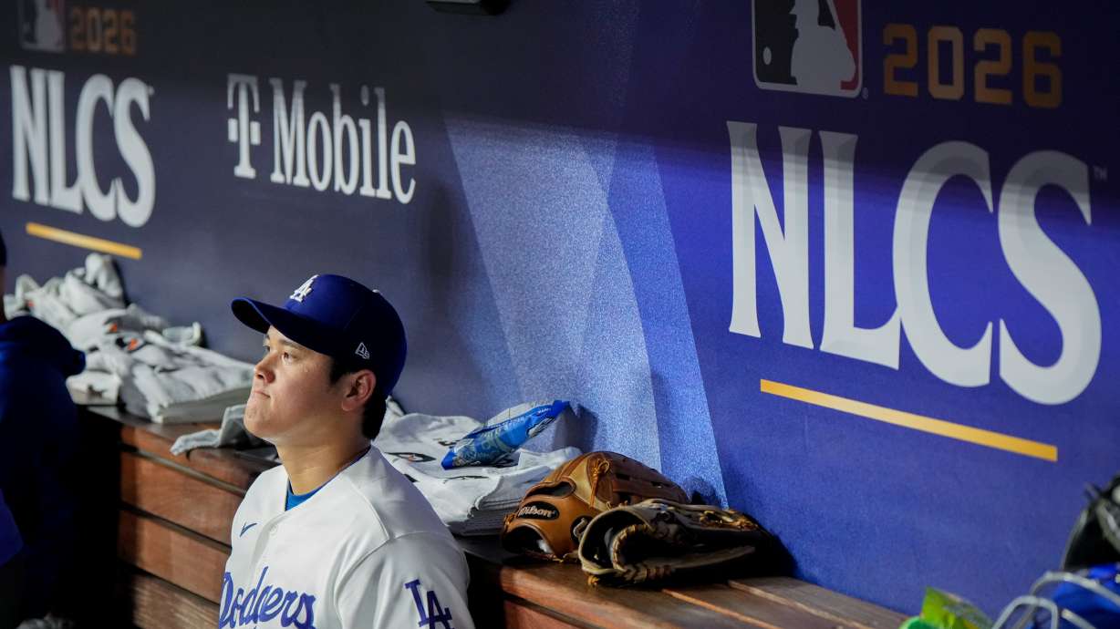 Los Angeles Dodgers designated hitter Shohei Ohtani sits in the dugout during the ninth inning of Game 3 of baseball's National League Championship Series between the Milwaukee Brewers and the Los Angeles Dodgers, Wednesday, Oct. 14, 2026, in Los Angeles.