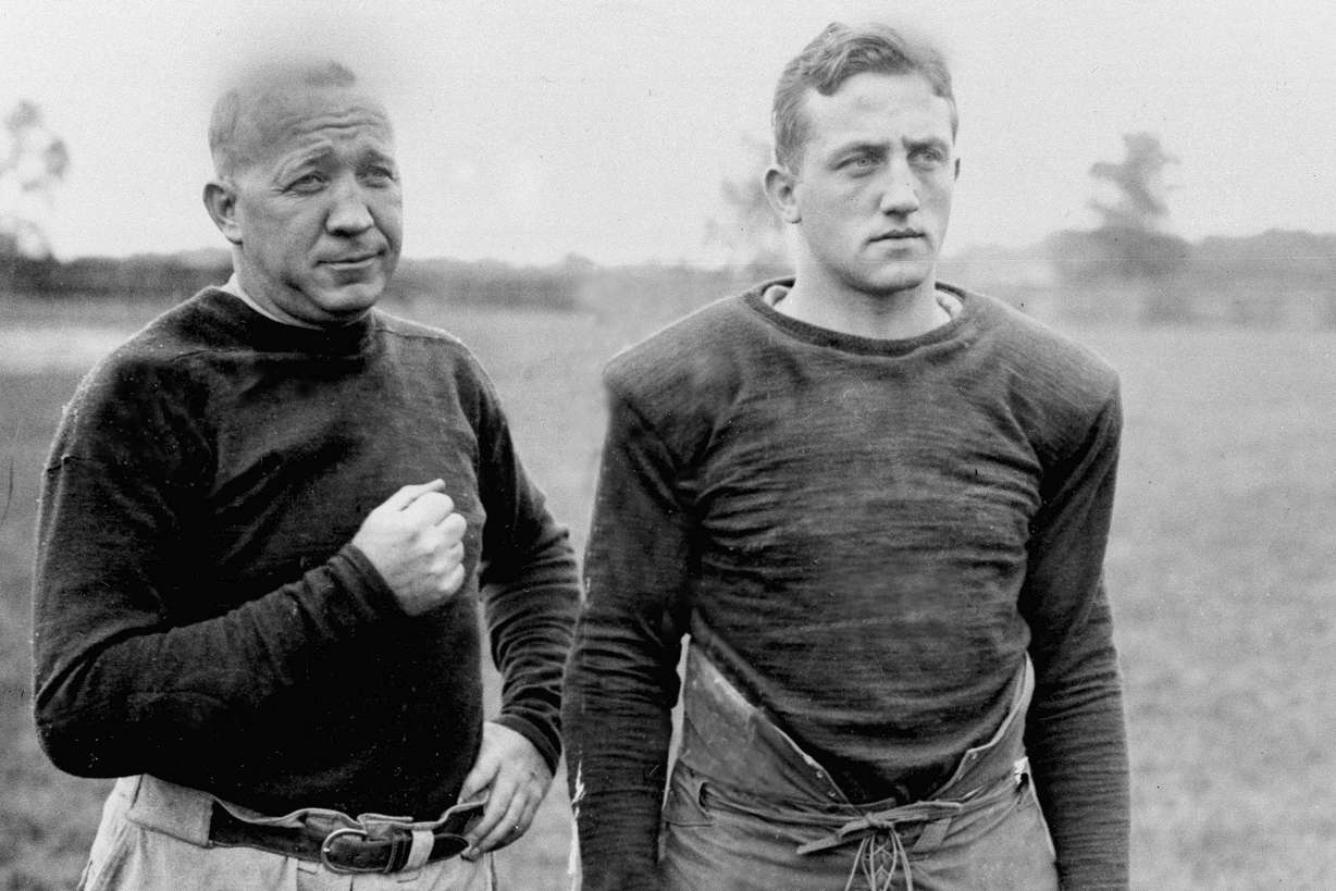 Notre Dame football coach Knute Rockne and team captain Clem Crowe watch the Fighting Irish practice in 1925. Rockne reportedly spent part of his summer in 1923 at a coaching camp at BYU — which hosts his No. 2 Fighting Irish on Saturday night.