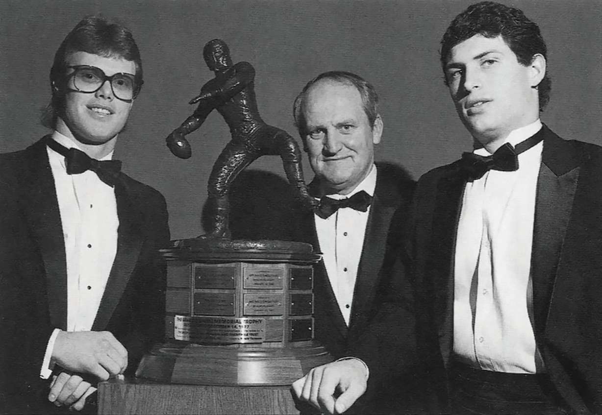 BYU quarterbacks Jim McMahon and Steve Young with head coach LaVell Edwards at the Davey O'Brien Awards ceremony. The school has a long tradition of being a quarterback factory.