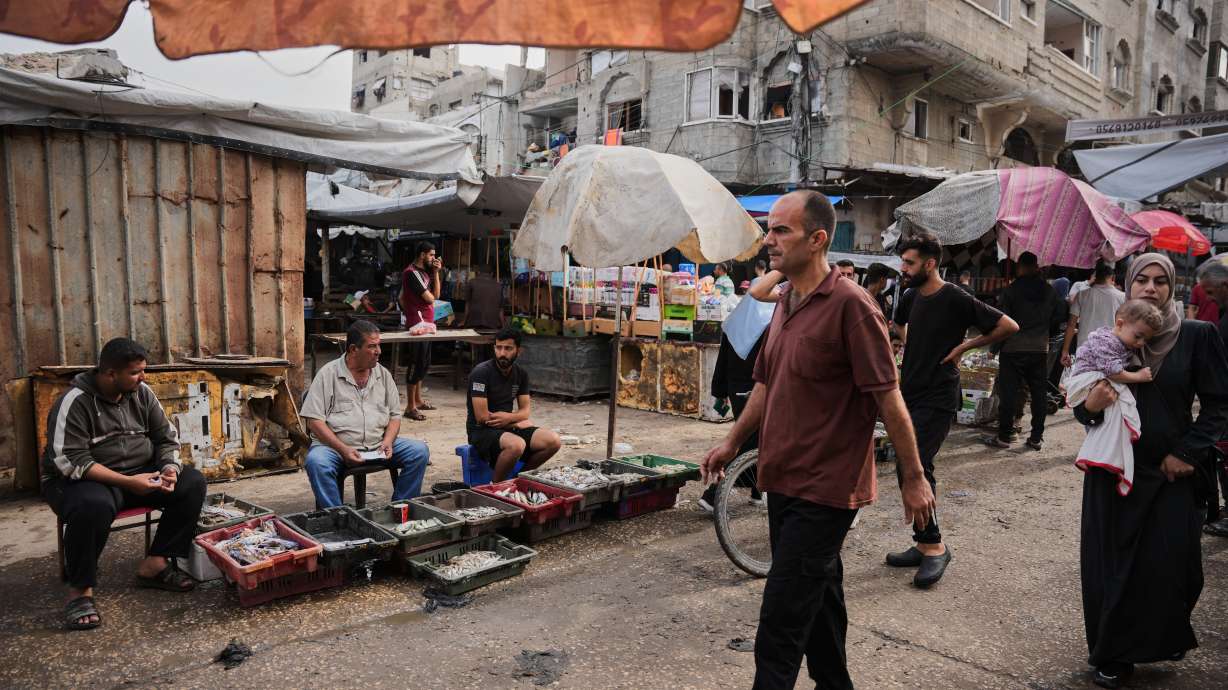 Palestinians walk through a market in the Al-Shati refugee camp in Gaza City on Oct. 14. No commercial goods have entered the Gaza Strip for two days, Israeli authorities said Thursday. The reason is disputed by Palestinian importers.