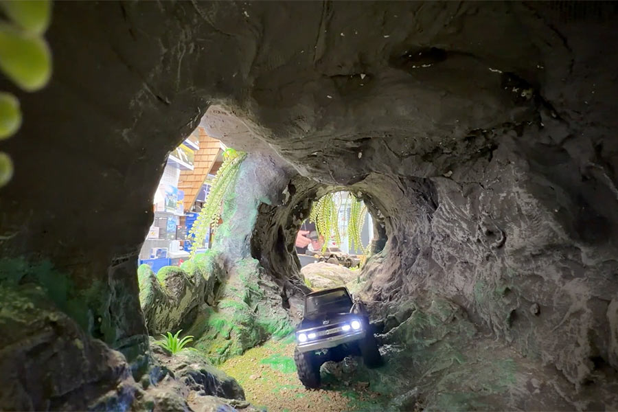 East Idaho News reporter Logan Ramsey drives a remote-control car through the obstacle course tunnel at OCDRC Hobby Shop in Pocatello, Idaho, on Wednesday. Shop owner Bryce Shurtliff is working to bring more remote-control hobbyist newcomers into his fold.
