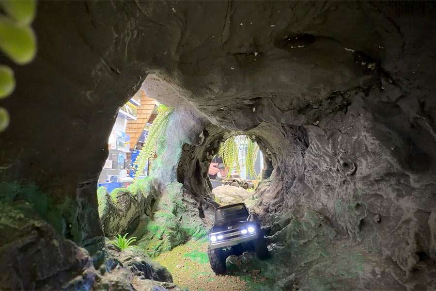 East Idaho News reporter Logan Ramsey drives a remote-control car through the obstacle course tunnel at OCDRC Hobby Shop in Pocatello, Idaho, on Wednesday. Shop owner Bryce Shurtliff is working to bring more remote-control hobbyist newcomers into his fold.