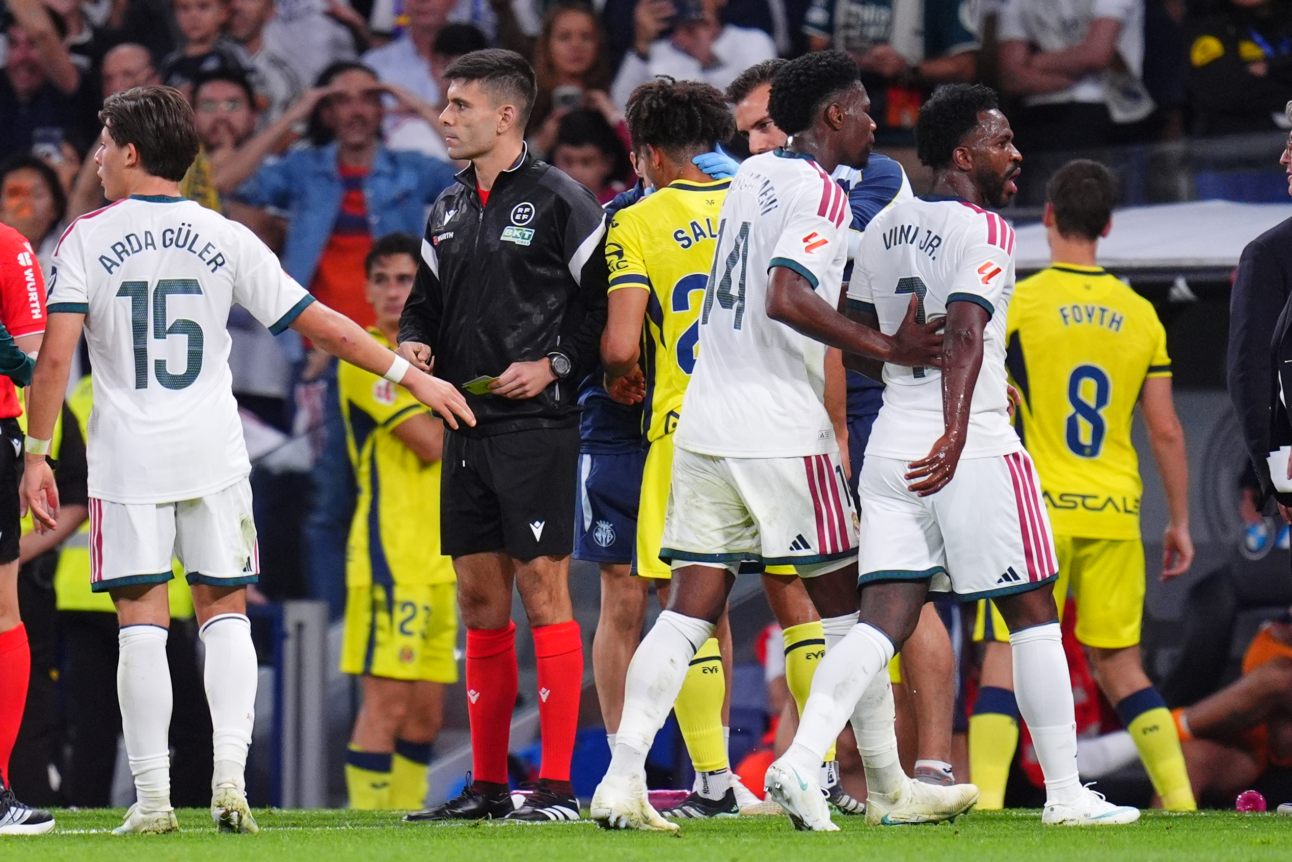 Real Madrid's Vinicius Junior, right, leaves the pitch after being shown a red card during the La Liga soccer match between Real Madrid and Villarreal in Madrid, Spain, Saturday, Oct. 10, 2026. 