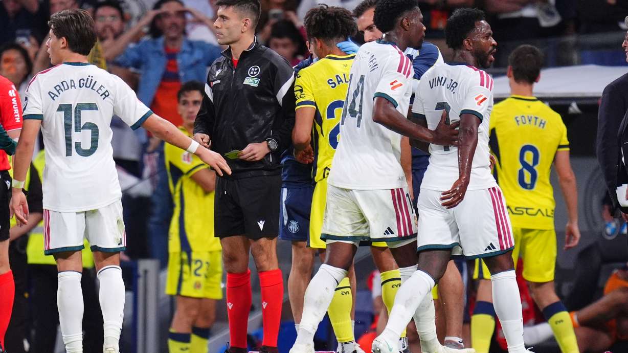 Real Madrid's Vinicius Junior, right, leaves the pitch after being shown a red card during the La Liga soccer match between Real Madrid and Villarreal in Madrid, Spain, Saturday, Oct. 10, 2026.