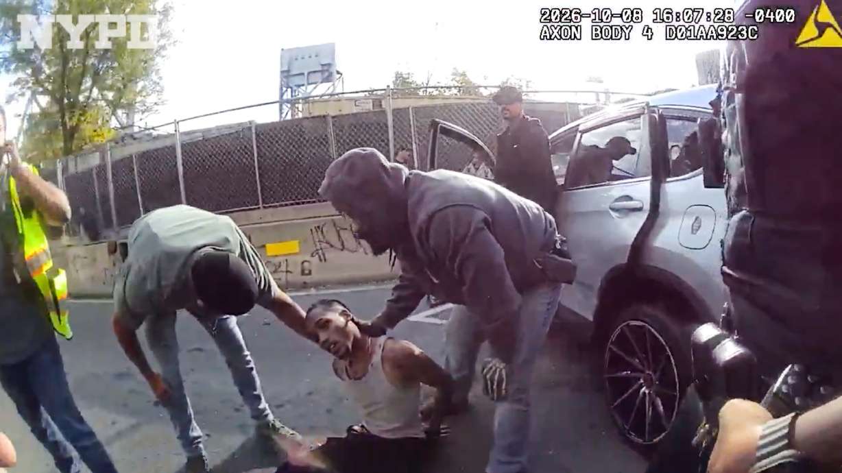 In this image taken from police-worn body camera video released the New York City Police Department, law enforcement personnel tend to a Oscar Belgal, 28, a Dominican man who was shot by Federal immigration officers, Oct. 8 in New York, as he drove his car with a 5-year-old boy inside. Belgal made his first court appearance on Thursday.