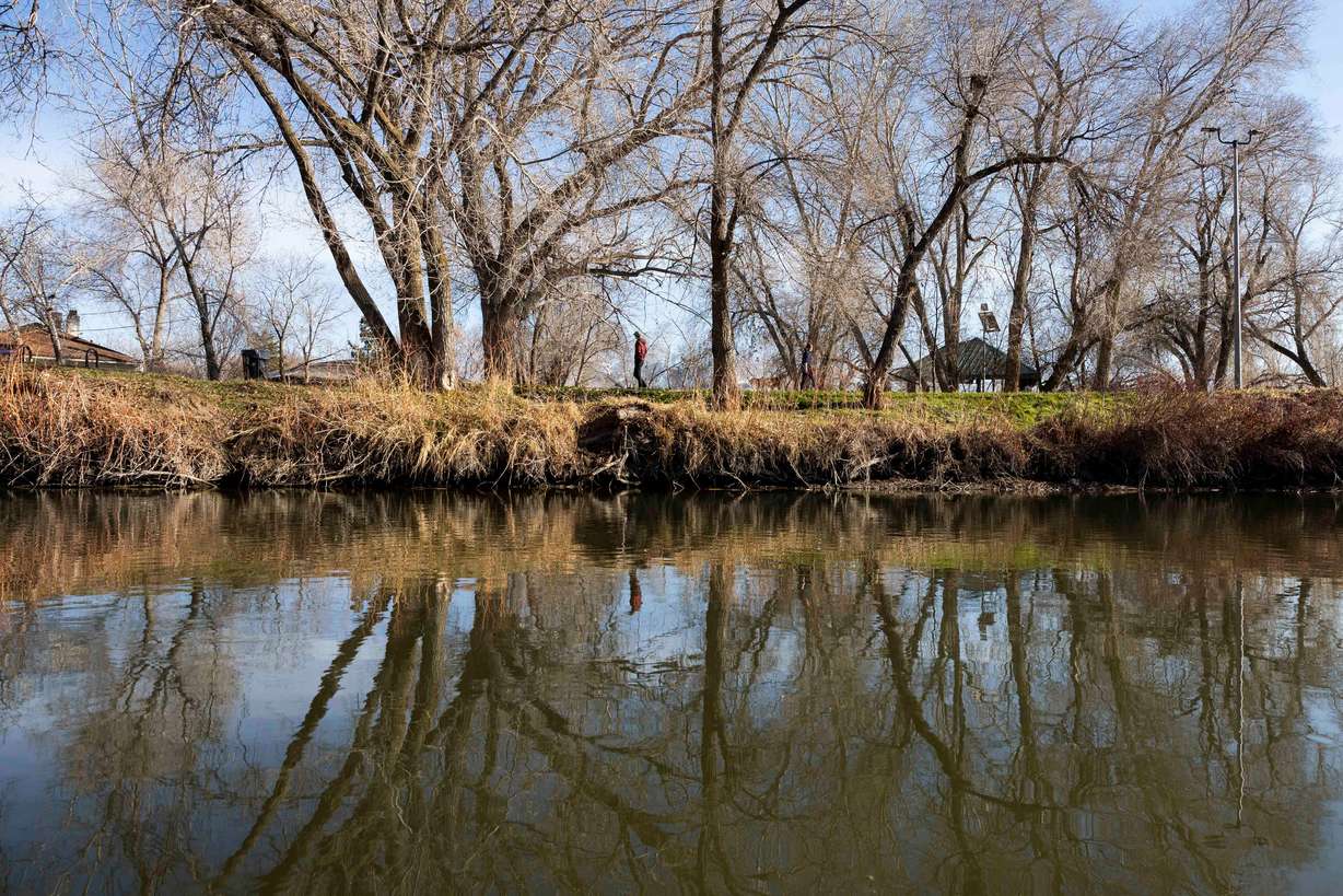 People walk along the Jordan River Trail in Salt Lake City on Monday, Feb. 2.