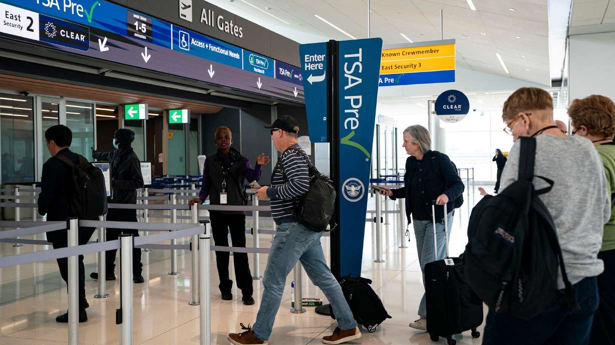 Travelers arrive at the TSA Precheck security line at Denver International Airport in Denver, on March 23.