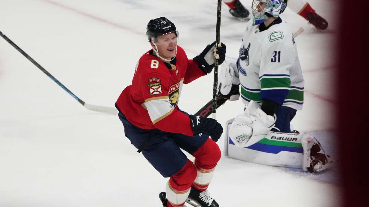 Florida Panthers left wing Brady Tkachuk (8) celebrates after scoring the game winning goal against Vancouver Canucks goaltender Leevi Meriläinen (31) during overtime in an NHL hockey game, Thursday, Oct. 15, 2026, in Sunrise, Fla.