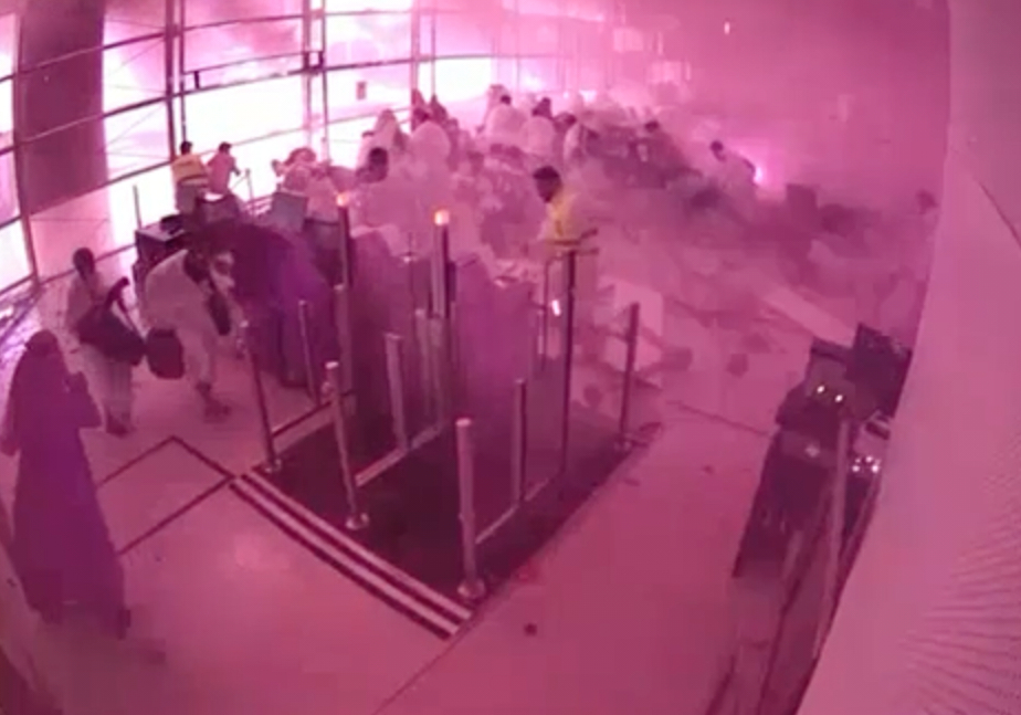 This image from CCTV video released by Saudi Arabia's Media Ministry shows passengers taking cover as flames and smoke fill part of King Khalid International Airport in Riyadh, Saudi Arabia, during what authorities described as a strike at the airport on Saturday, Oct. 10, 2026. 
