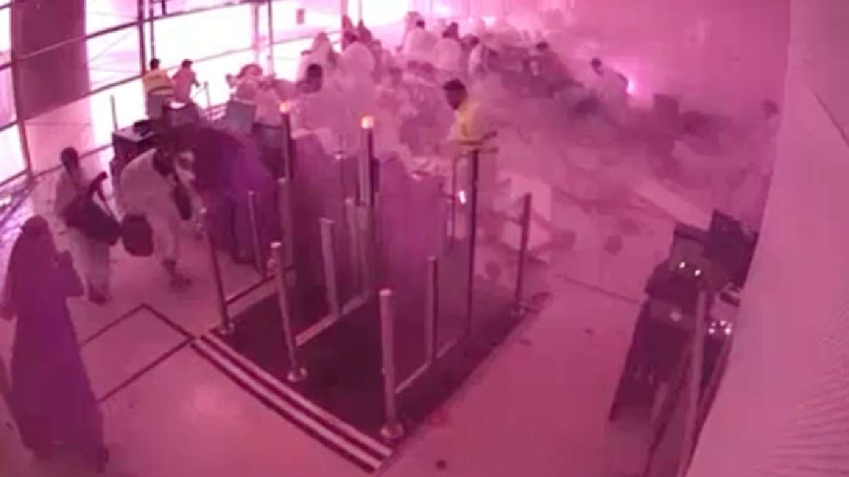 This image from CCTV video released by Saudi Arabia's Media Ministry shows passengers taking cover as flames and smoke fill part of King Khalid International Airport in Riyadh, Saudi Arabia, during what authorities described as a strike at the airport on Saturday, Oct. 10, 2026.
