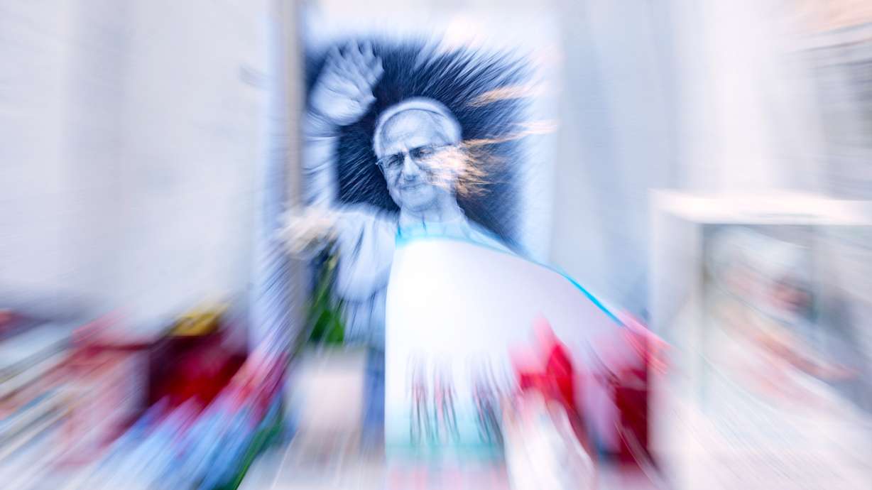 An image of Pope Leo XIV is seen under the statue of late Pope St. John Paul II at the Agostino Gemelli Polyclinic where the pontiff is hospitalized, in Rome, Friday. Doctors said tests confirmed his "continued improvement" following lung surgery.