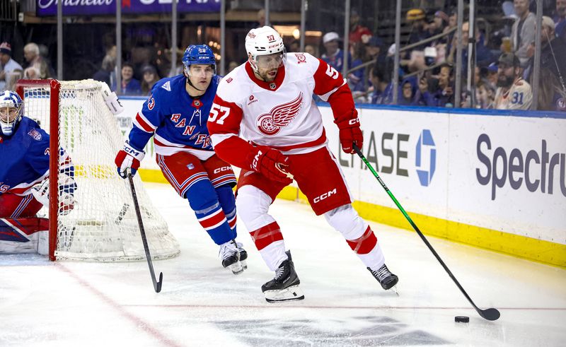 Apr 4, 2026; New York, New York, USA; Detroit Red Wings left wing David Perron (57) plays the puck in front of New York Rangers left wing Conor Sheary (43) during the first period at Madison Square Garden.