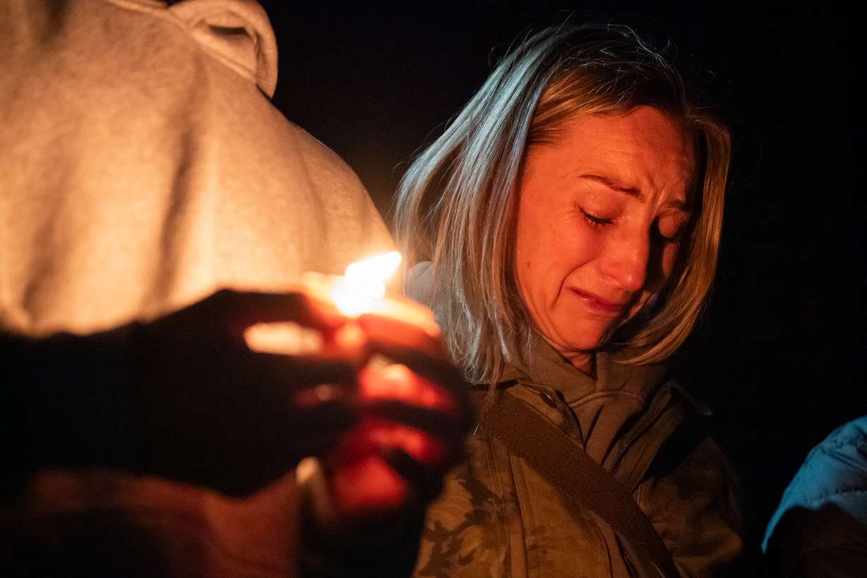 Dara Crawford cries during a candlelight vigil at Drake Park following a deadly shooting at Silver Rail Elementary School in Bend, Ore. on Thursday. Four people were killed, including the shooter.