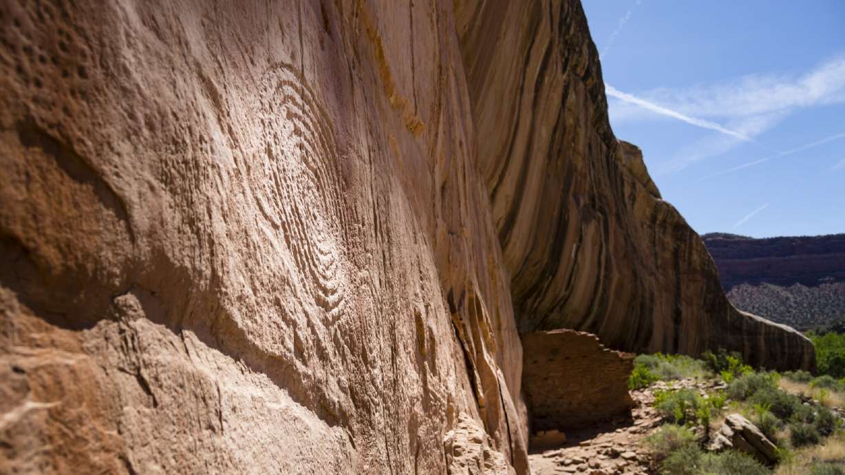 Ruins and a petroglyph along the sheer face of Arch Canyon in Bears Ears National Monument. A judge lifted stays on lawsuits against President Donald Trump for downsizing Bears Ears and Grand Staircase-Escalante national monuments on Tuesday.