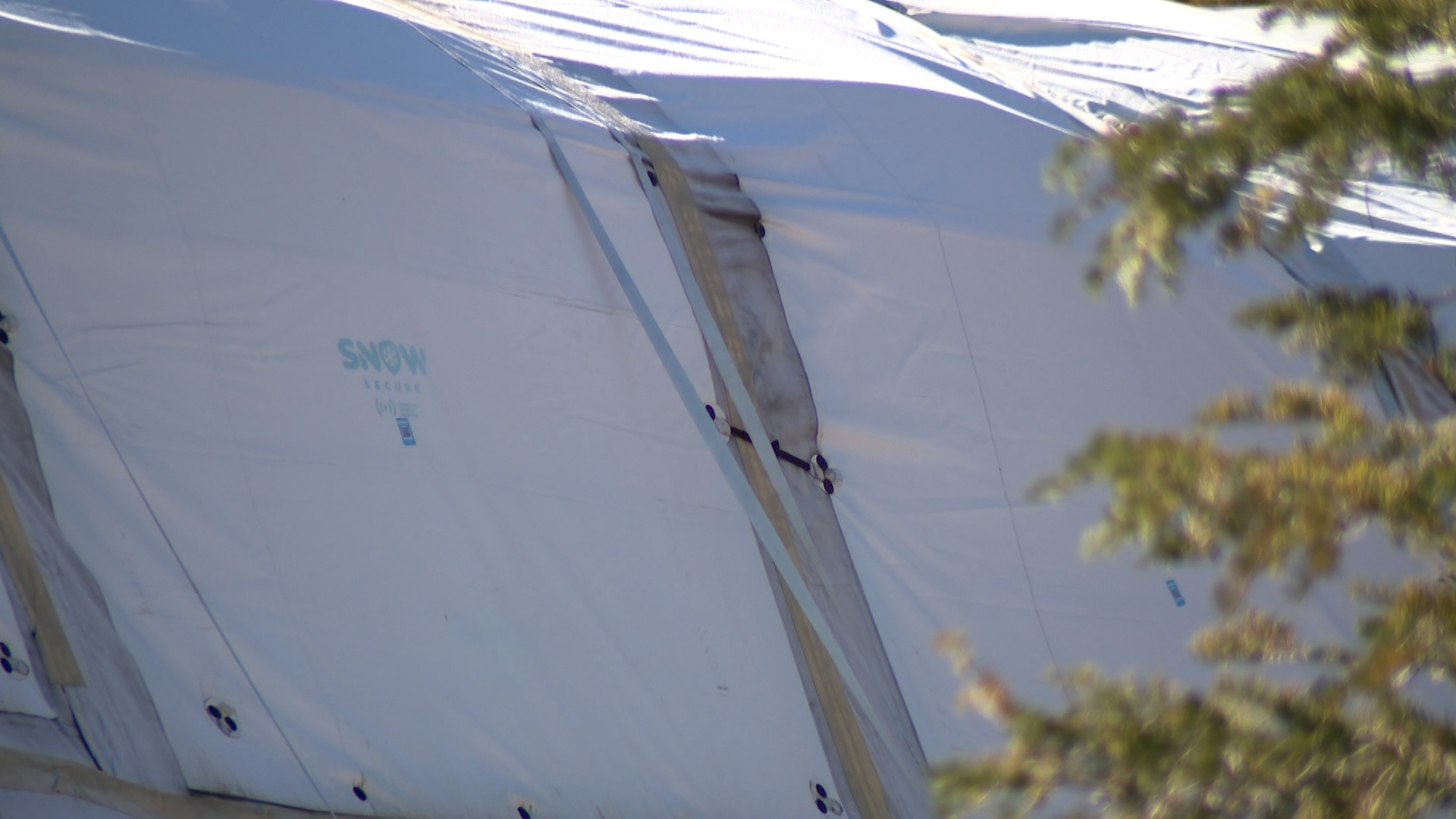 Earlier this year, crews at Soldier Hollow made a pile of snow roughly the size of a football field and about 25 feet deep. They then covered it with special insulating tarps and mats designed to keep the snow from melting during the warmer months.