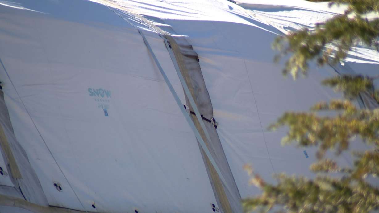 Earlier this year, crews at Soldier Hollow made a pile of snow roughly the size of a football field and about 25 feet deep. They then covered it with special insulating tarps and mats designed to keep the snow from melting during the warmer months.