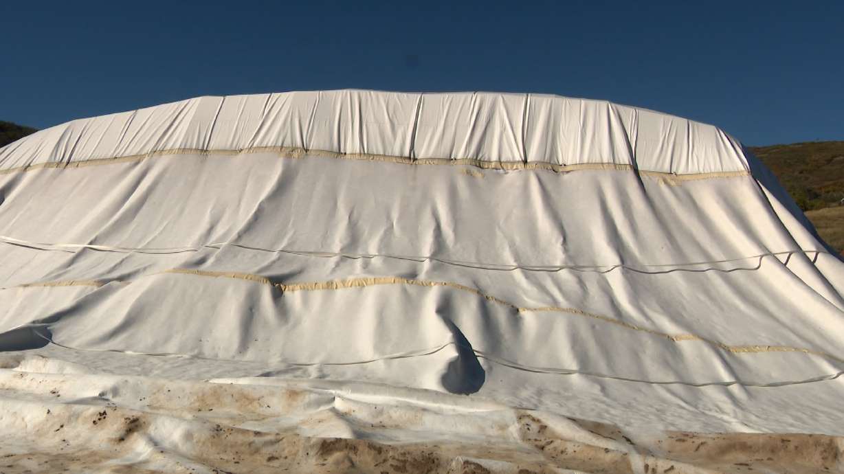 Earlier this year, crews at Soldier Hollow made a pile of snow roughly the size of a football field and about 25 feet deep. They then covered it with special insulating tarps and mats designed to keep the snow from melting during the warmer months.