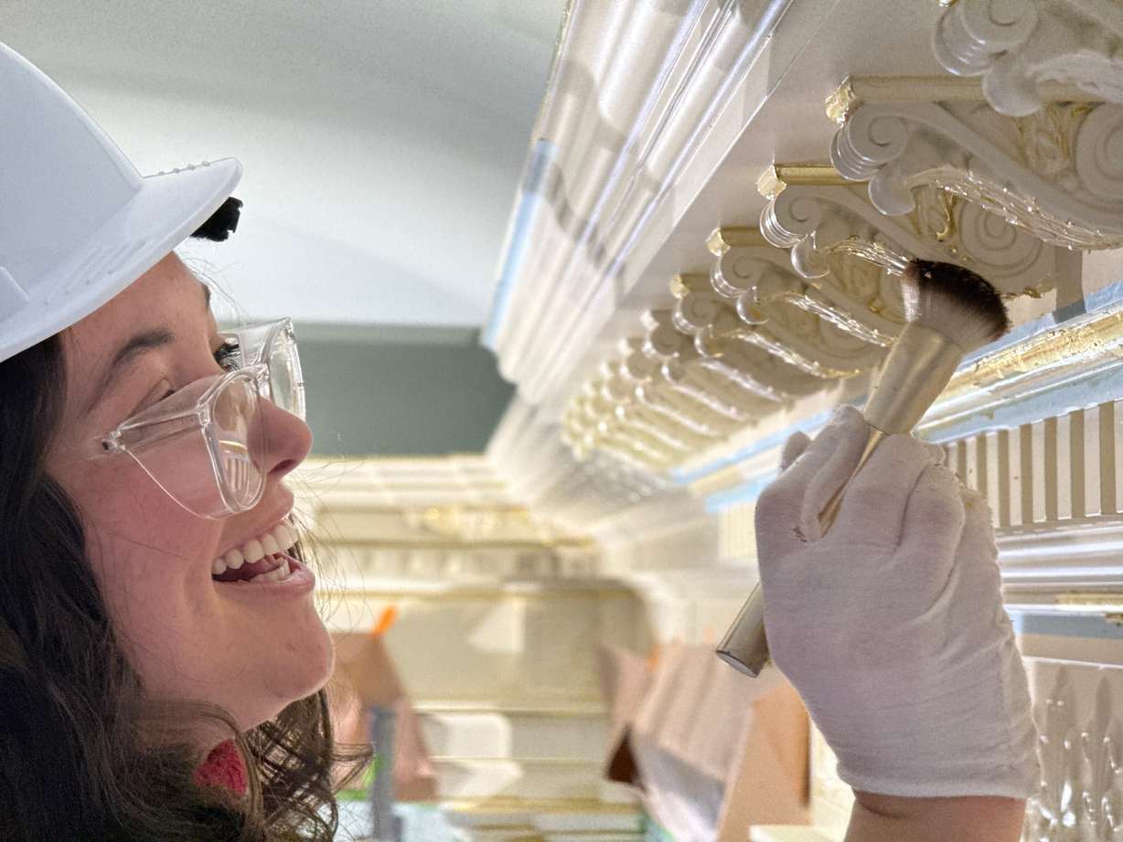 Alex Cazier of Alabama, USA, adds gold leaf as part of the finishing work inside the Salt Lake Temple during filming for “Dedicate.”
