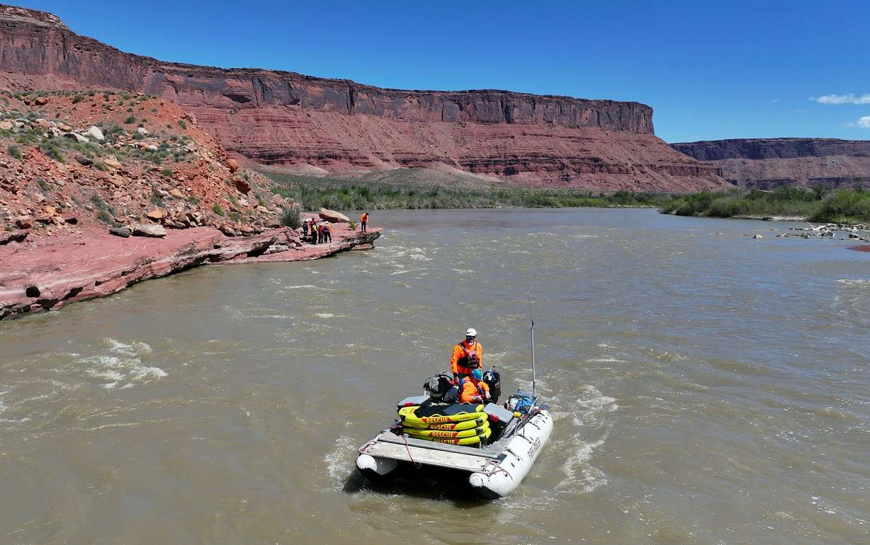 Canyonlands National Park backcountry river ranger and former river district ranger Steve Young, nicknamed Tberry, stands to drive a boat while teaching a Swift Water Incident Management training course on the Colorado River near Onion Creek rapids in Grand County on April 29, 2025. Bill Campbell, emergency room physician and medical director for Great Smoky Mountains National Park, the Obed Wild and Scenic River, and the Big South Fork National River and Recreation Area, sits on the boat with him.