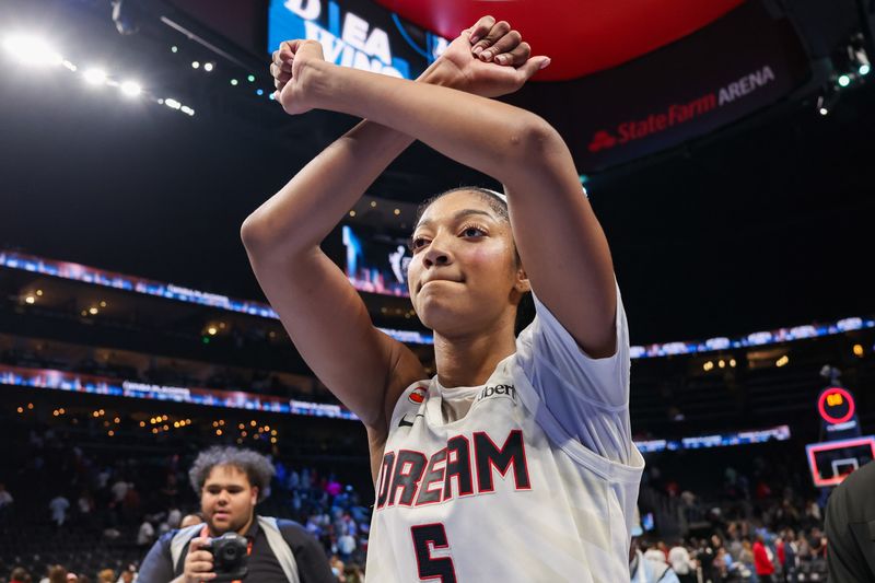 FILE PHOTO: Oct 4, 2026; Atlanta, Georgia, USA; Atlanta Dream forward Angel Reese (5) celebrates after a victory over the New York Liberty in game one of the second round for the 2026 WNBA Playoffs at State Farm Arena.