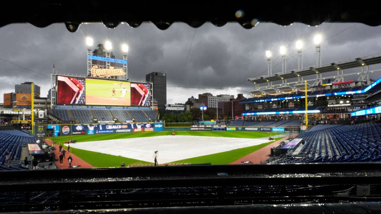 The field is covered before Game 4 of an American League Championship Series baseball game between the Cleveland Guardians and the Tampa Bay Rays in Cleveland, Friday, Oct. 16, 2026.