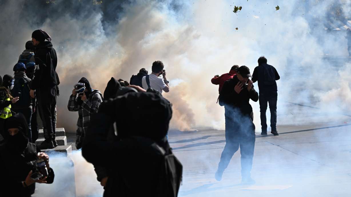 Protesters scuffle with police during a demonstration against rising living costs, joining students' grievances, in Paris, Saturday.