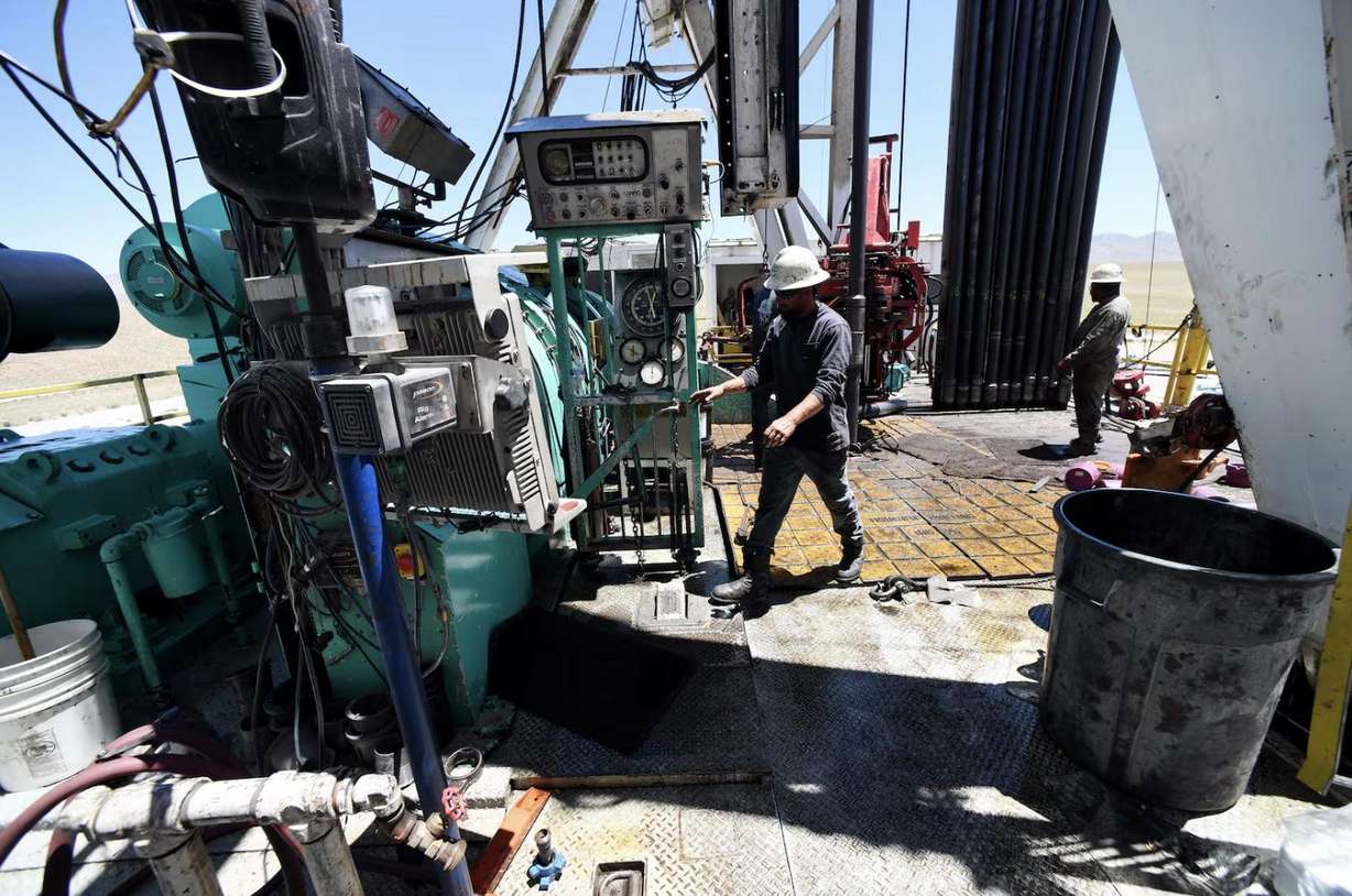 Crew members work on a drilling rig at the FORGE geothermal demonstration site near Milford.