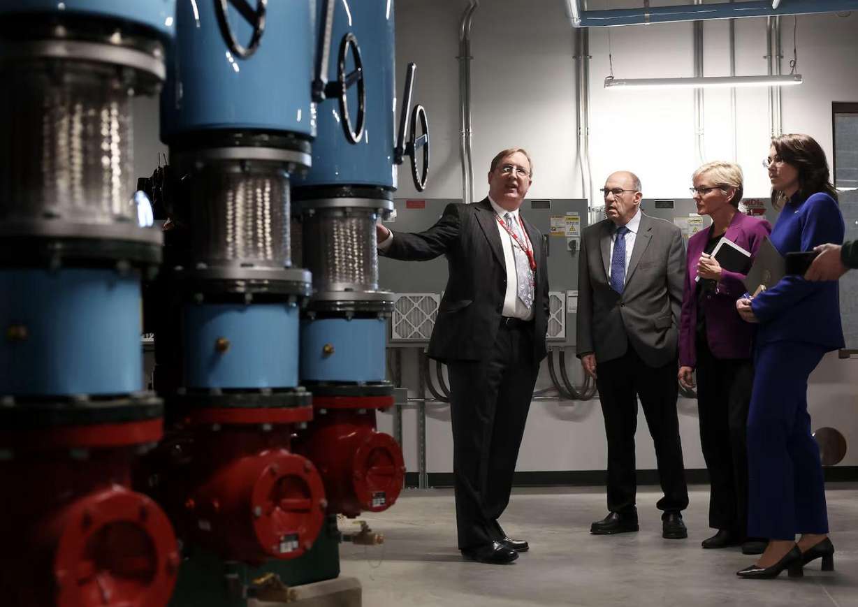 John Palo, facility manager at the University of Utah, left, speaks with Dr. Joseph Moore, the managing principal investigator of the Utah FORGE site, U.S. energy secretary Jennifer M. Granholm and Lt. Gov. Deidre M. Henderson in the pump room of Gardner Commons at the University of Utah in Salt Lake City on Feb. 8, 2023.