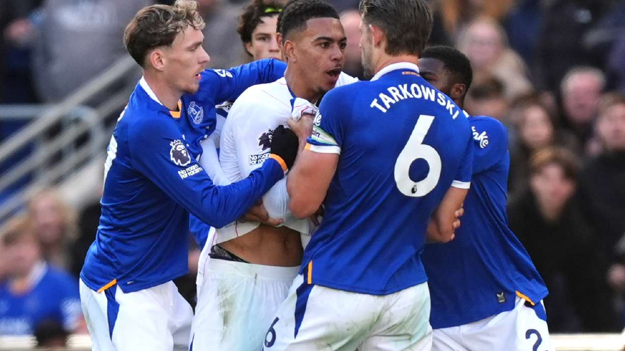 Tempers fray between Chelsea's Morgan Rogers, center, and Everton's James Tarkowski, resulting in yellow cards to both players, during the English Premier League soccer match between Everton and Chelsea in Liverpool, England, Saturday, Oct. 17, 2026.