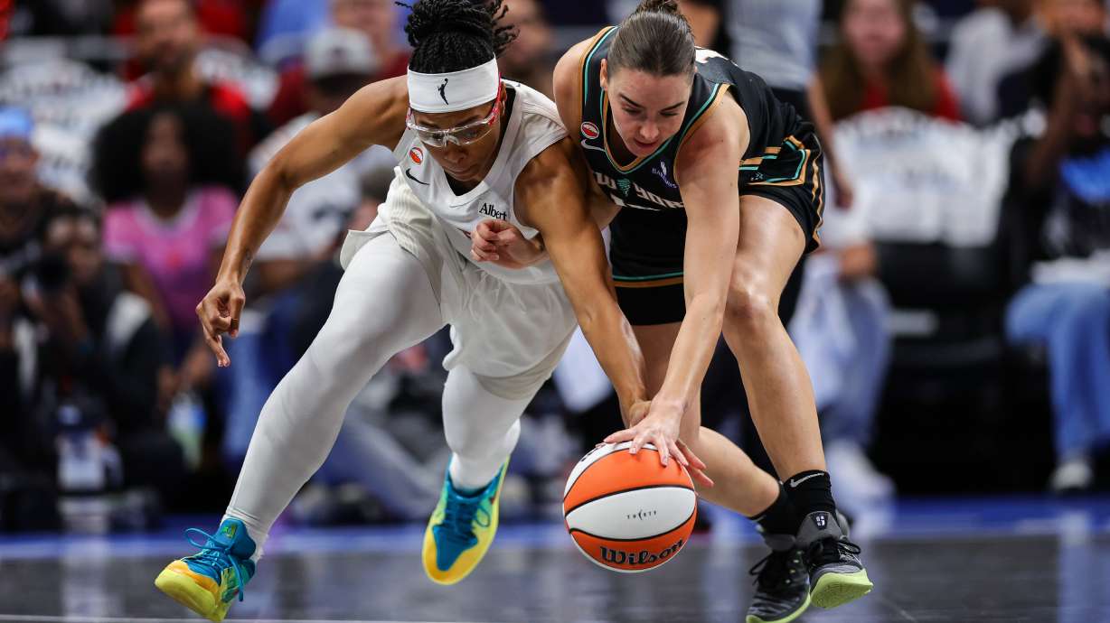 Atlanta Dream guard Allisha Gray, left, fights for possession with New York Liberty guard Pauline Astier, right, during the first half of Game 1 of the WNBA basketball semifinals Sunday, Oct, 4, 2026, in Atlanta.