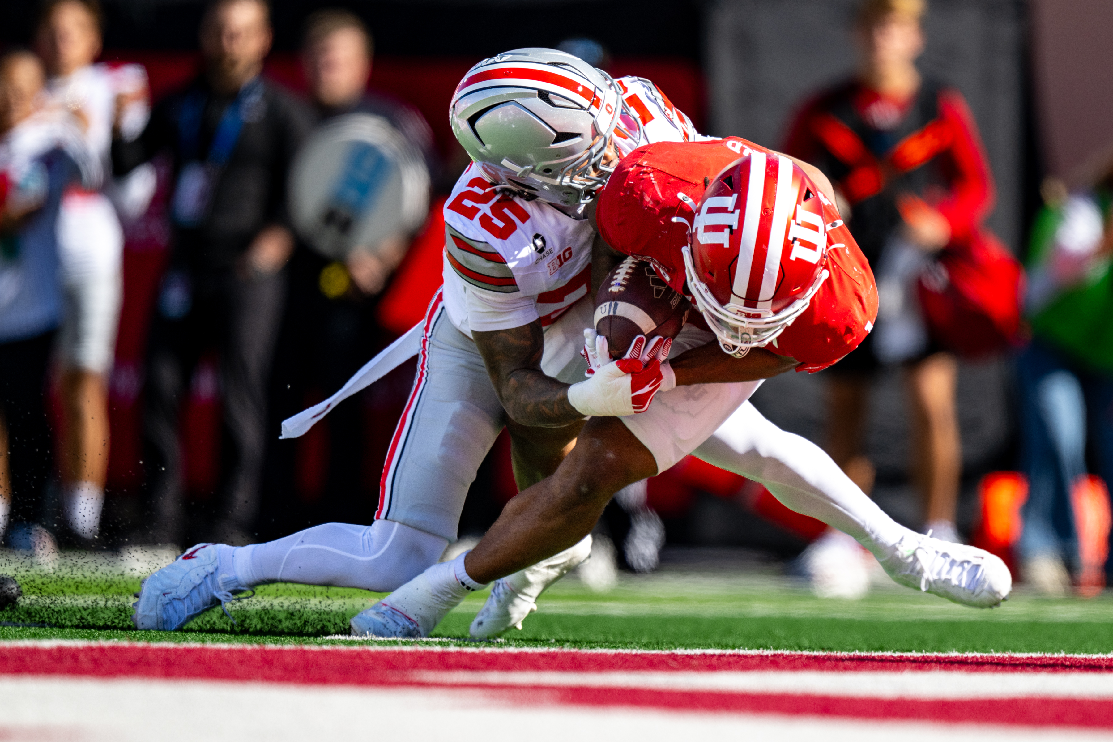 Indiana running back Turbo Richard (1) falls into the end zone to score while being hit by Ohio State cornerback Jay Timmons (25) during the first half of an NCAA college football game, Saturday, Oct. 17, 2026, in Bloomington, Ind. 