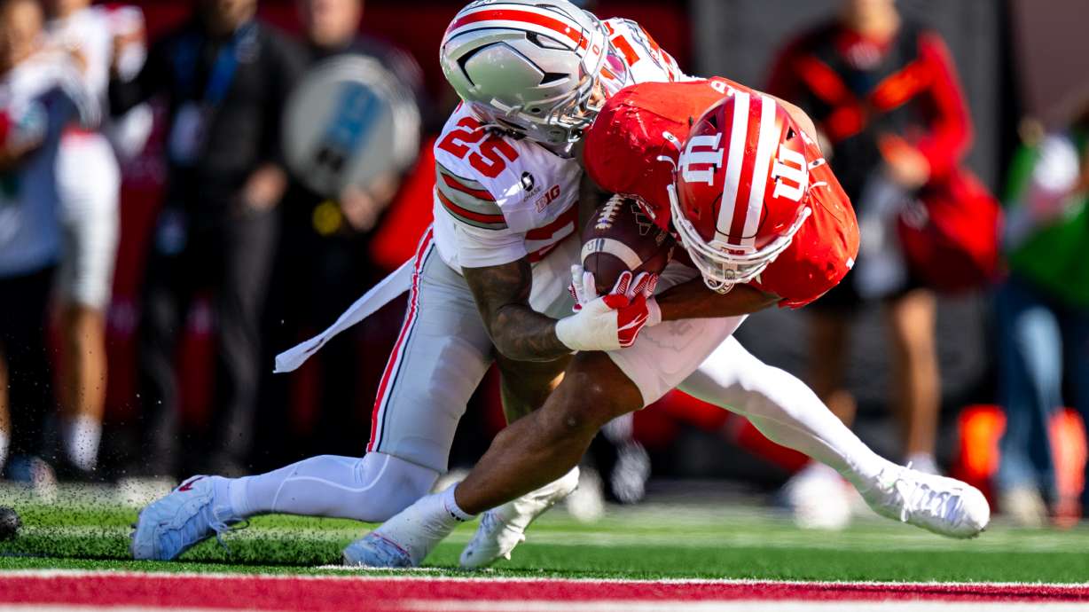 Indiana running back Turbo Richard (1) falls into the end zone to score while being hit by Ohio State cornerback Jay Timmons (25) during the first half of an NCAA college football game, Saturday, Oct. 17, 2026, in Bloomington, Ind.