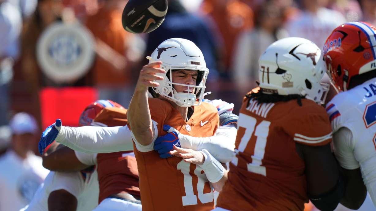 Texas quarterback Arch Manning (16) is hit by Florida linebacker Jaden Robinson (29) as he throw during the first half of an NCAA college football game in Austin, Texas, Saturday, Oct. 17, 2026.