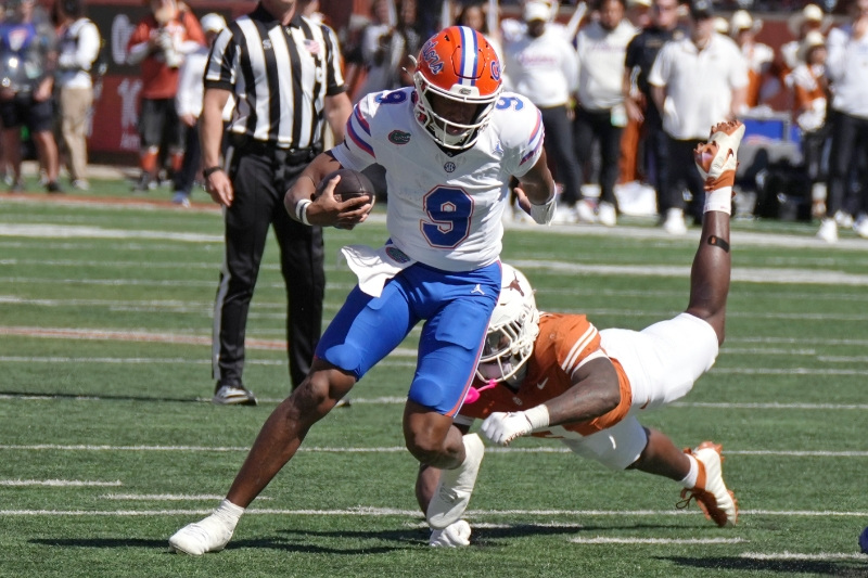 Oct 17, 2026; Austin, Texas, USA;  Florida Gators quarterback Tramell Jones Jr. (9) escapes a tackle from Texas Longhorns linebacker Rasheem Biles (3) during the first half at Darrell K Royal-Texas Memorial Stadium.