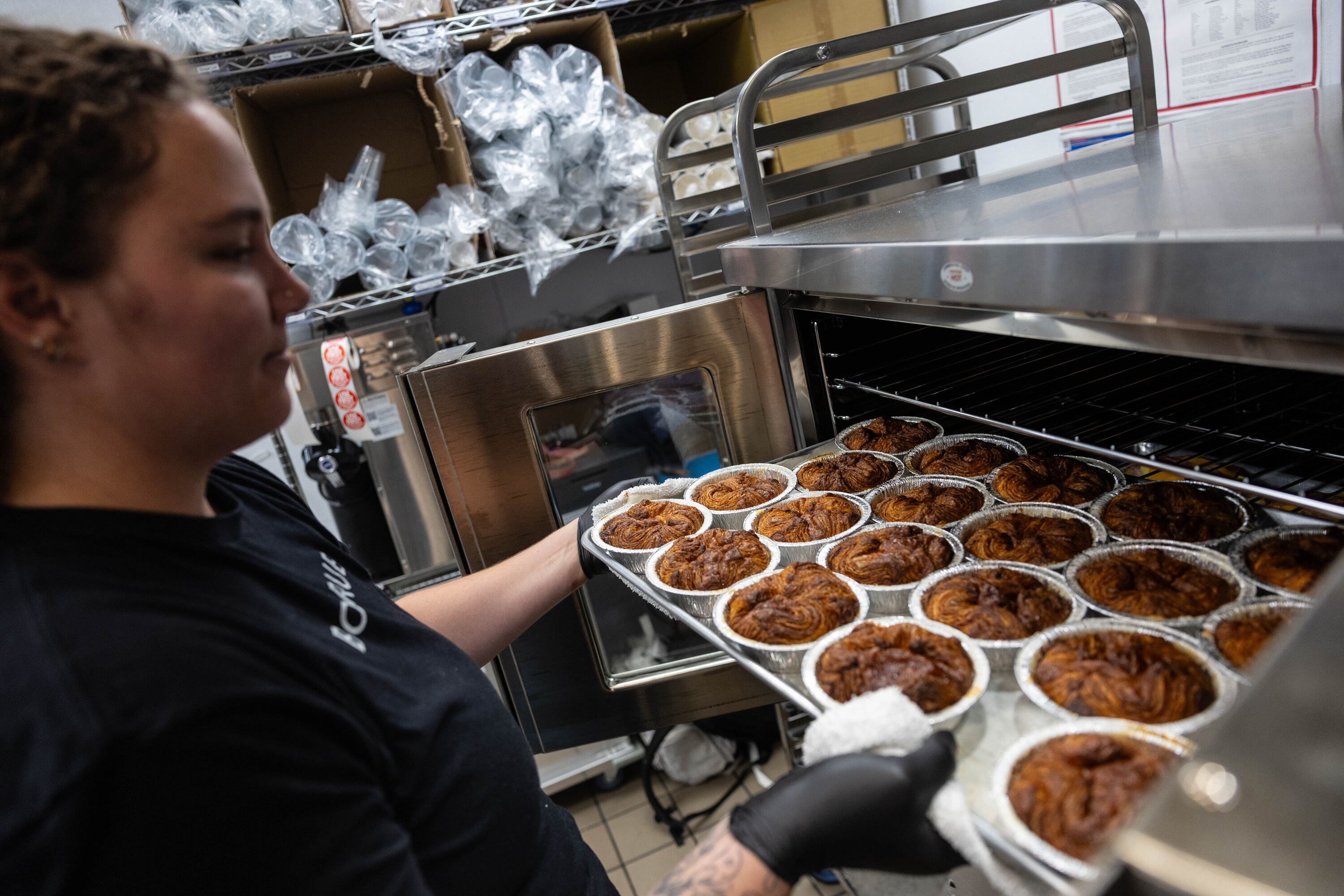 Manager Shailee Bundy removes Kouign-amann pastries from the oven at the Bonrue Bakery’s new location in Provo on Sunday, Oct. 11.