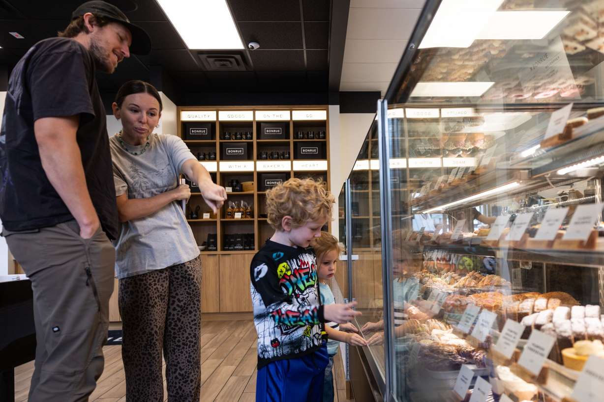 A family looks at the collection of pastries offered at the Bonrue Bakery’s new location in Provo on Sunday, Oct. 11.