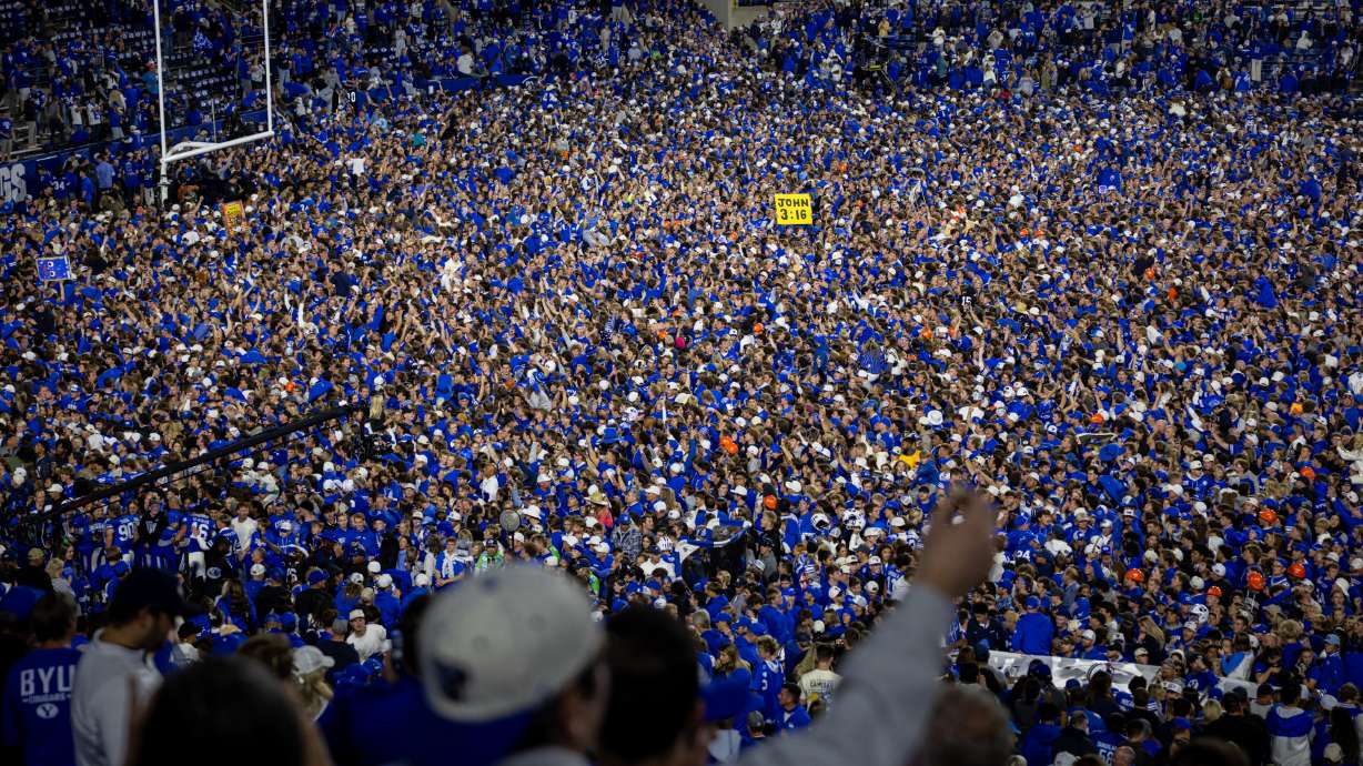 BYU Cougars fans rush the field after the BYU Cougars won against the Notre Dame Fighting Irish in a football game at LaVell Edwards Stadium in Provo on Saturday, Oct. 17, 2026.