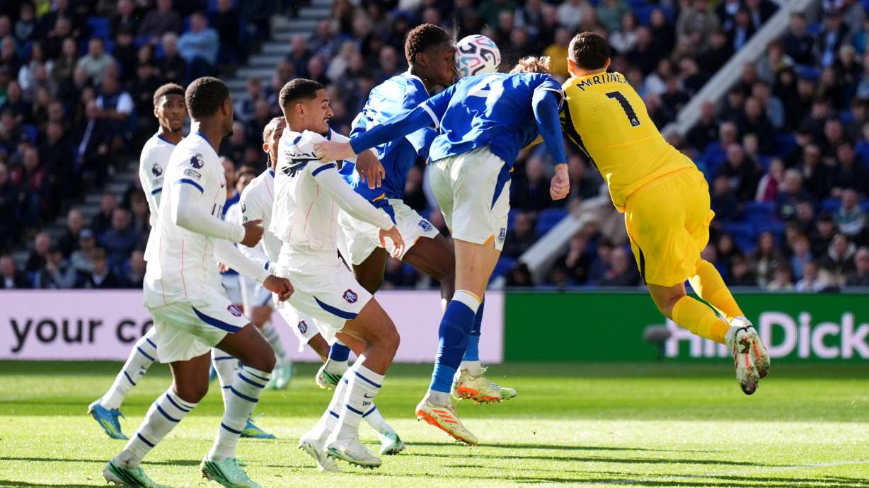 Chelsea goalkeeper Emiliano Martinez, right, picks up an injury during the English Premier League soccer match between Everton and Chelsea in Liverpool, England, Saturday, Oct. 17, 2026.