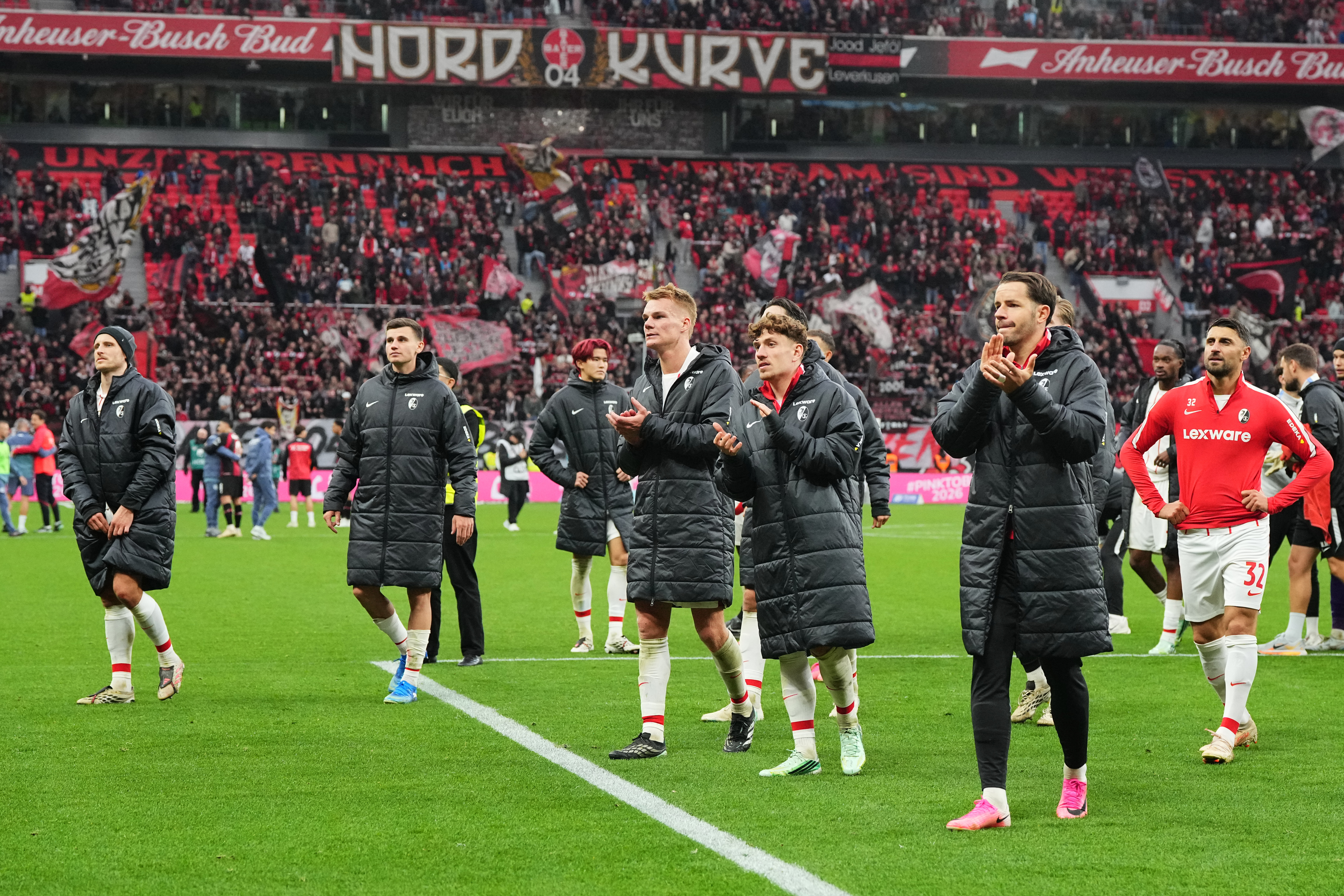 Freiburg's players walk in coats disappointed to their fans after losing the German Bundesliga soccer match between Bayer Leverkusen and SC Freiburg in Leverkusen, Germany, Sunday, Oct. 18, 2026. 