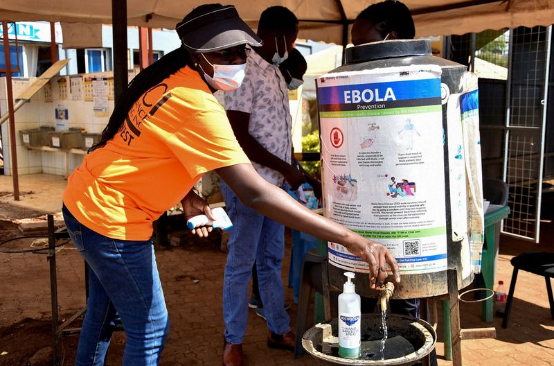 FILE PHOTO: A medical worker controls the sanitization point for travellers to wash their hands before entering the Kenya immigration services to access port health services at the Busia One Stop Border Post, crossing-point between Kenya and Uganda, after a man who had been living in the Democratic Republic of Congo travelled and died of a new Ebola outbreak involving the Bundibugyo species at the Nairobi Hospital, in Busia, Kenya October 8, 2026.