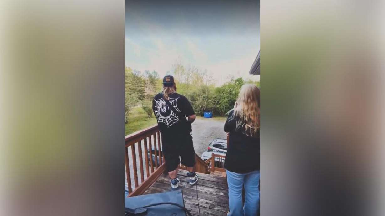A still image of a video showing an attempt to deter black bears by playing an electric guitar in western North Carolina.