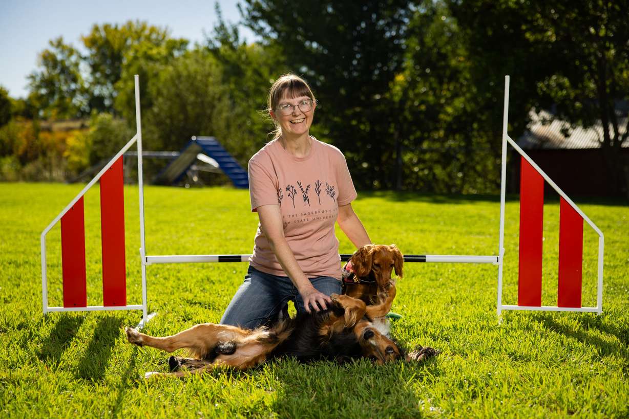 Tracy Mazur, a dog trainer and dog show judge who has been selected to be a judge at the Westminster Dog Show in New York in January 2027, poses with her dogs Quill and Ember next to a jump at Versa Dog Training, where she trains her dogs, in Layton on Sept. 30.
