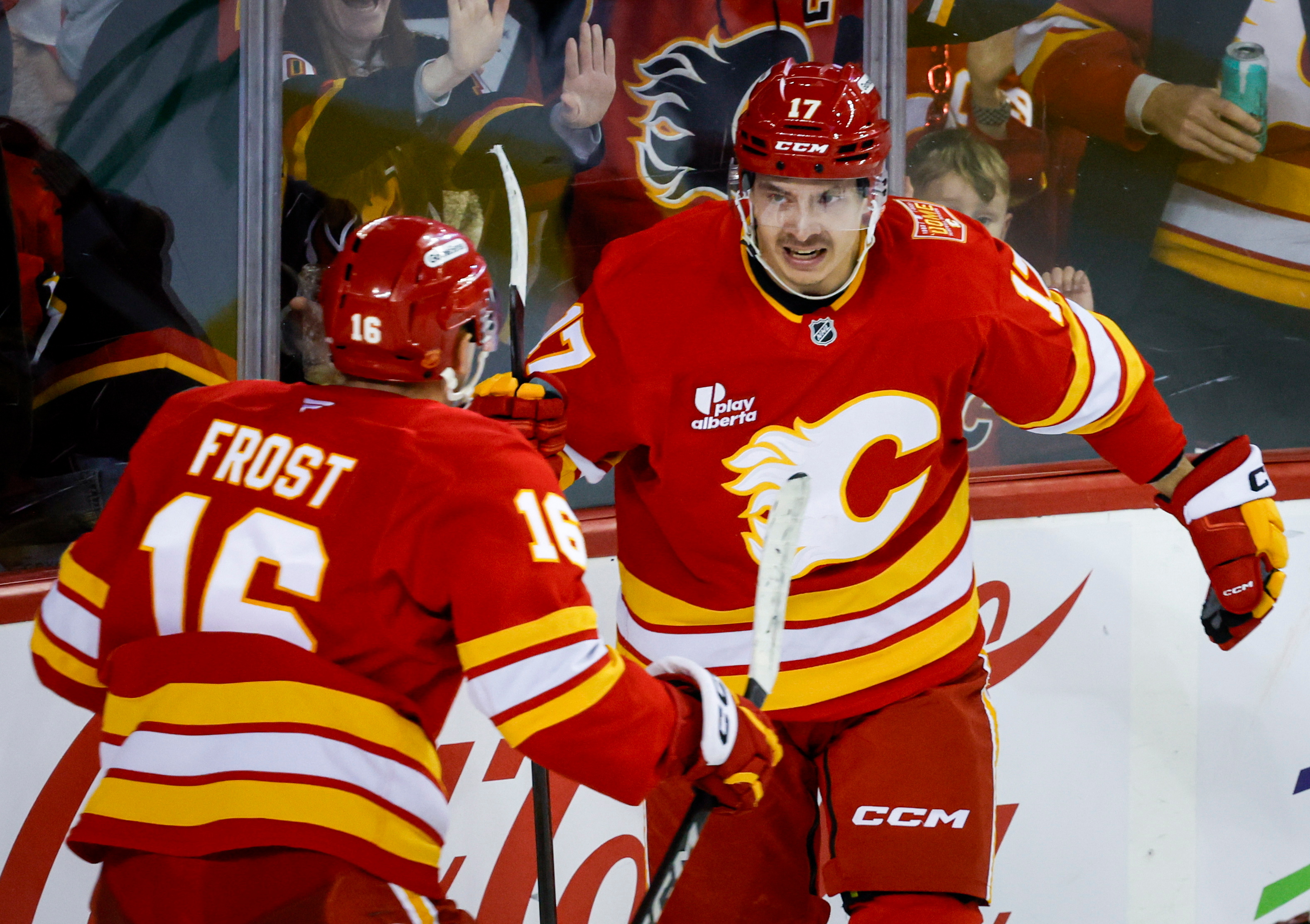 Calgary Flames' Yegor Sharangovich, right, celebrates his goal with teammate Morgan Frost during the third period of an NHL hockey game against the Carolina Hurricanes in Calgary, Alberta, Sunday, Oct. 18, 2026. 