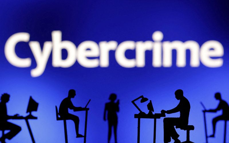FILE PHOTO: Figurines with computers and smartphones are seen in front the word "Cybercrime" in this illustration taken, February 19, 2024.