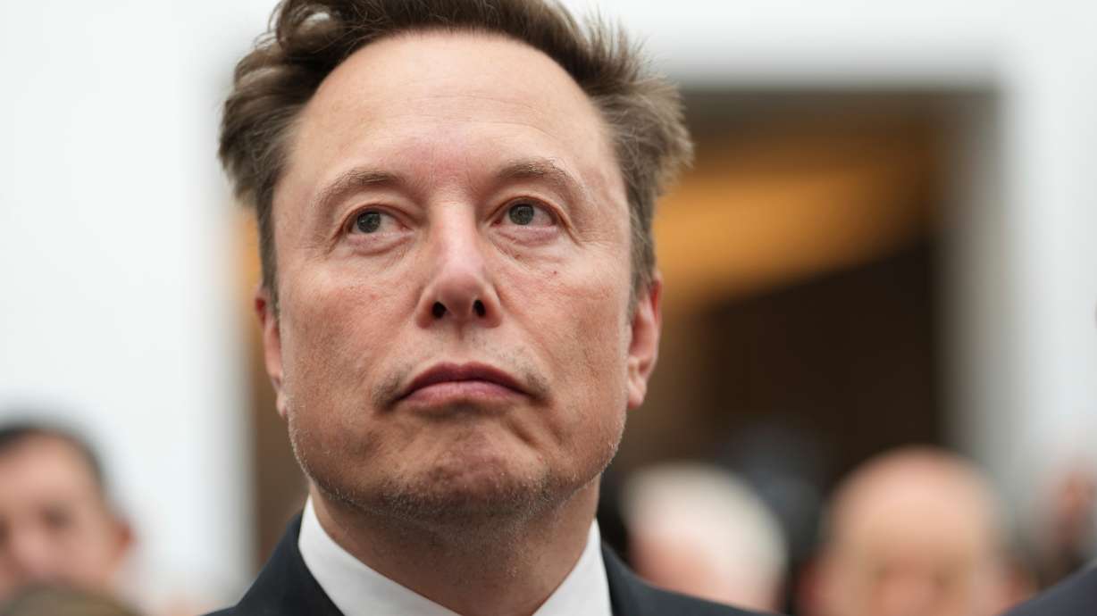 Elon Musk listens as President Donald Trump speaks during an event at the U.S. Institute of Peace, Oct. 8, in Washington.