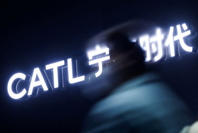 A person passes next to a logo of Chinese battery giant CATL before start of the company’s Tech Day event ahead of the Auto China show, in Beijing, China, April 21, 2026.