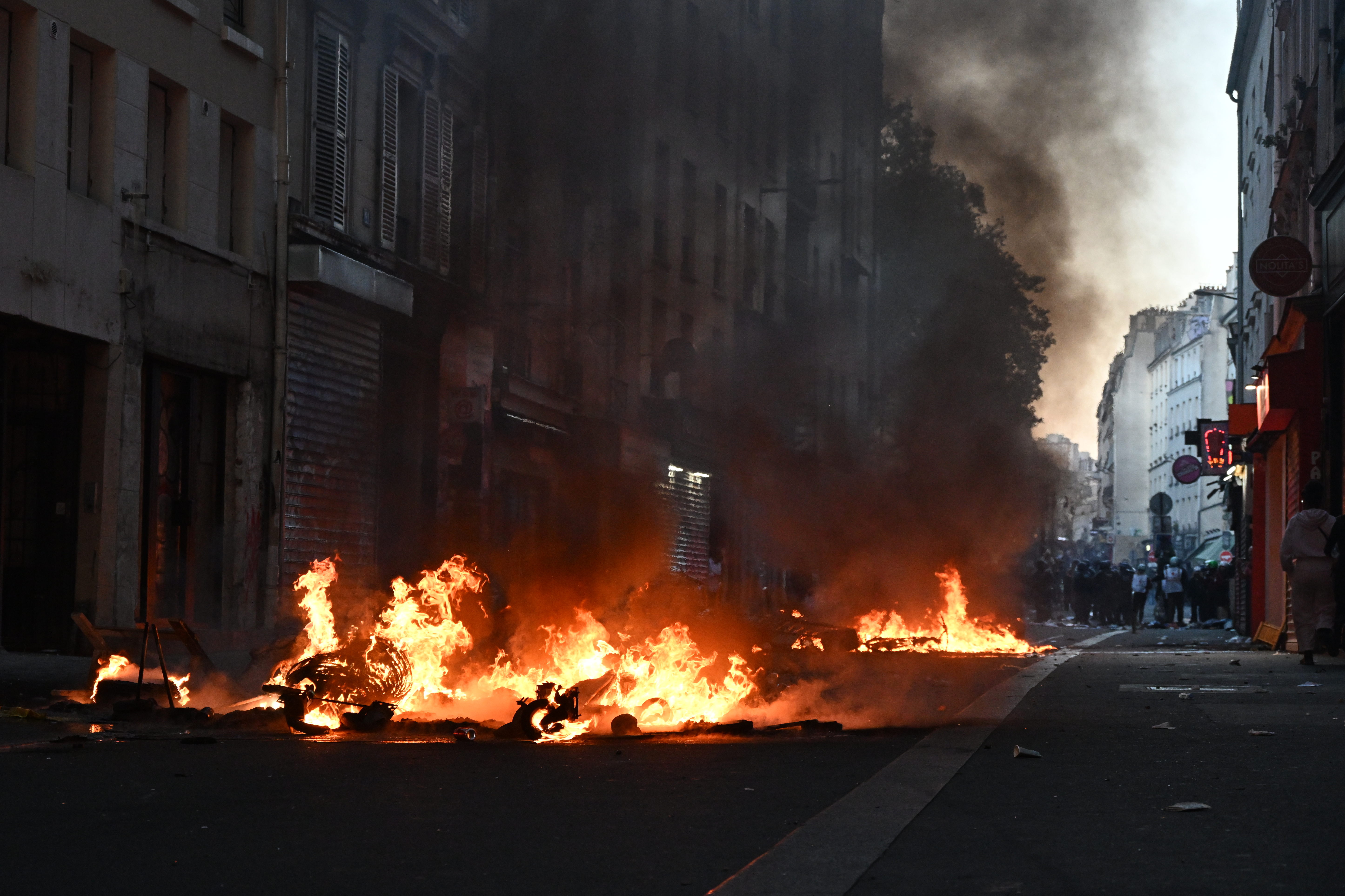 Trash burns during clashes between protestors and police officers during a demonstration against rising living costs, joining students' grievances, in Paris, Sunday, Oct. 18, 2026. 
