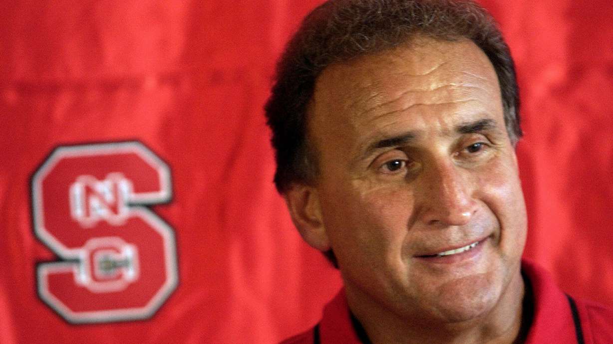 FILE - North Carolina State coach Chuck Amato answers questions from reporters during the team's media day, Aug. 12, 2001, at Carter-Finley Stadium in Raleigh, N.C.