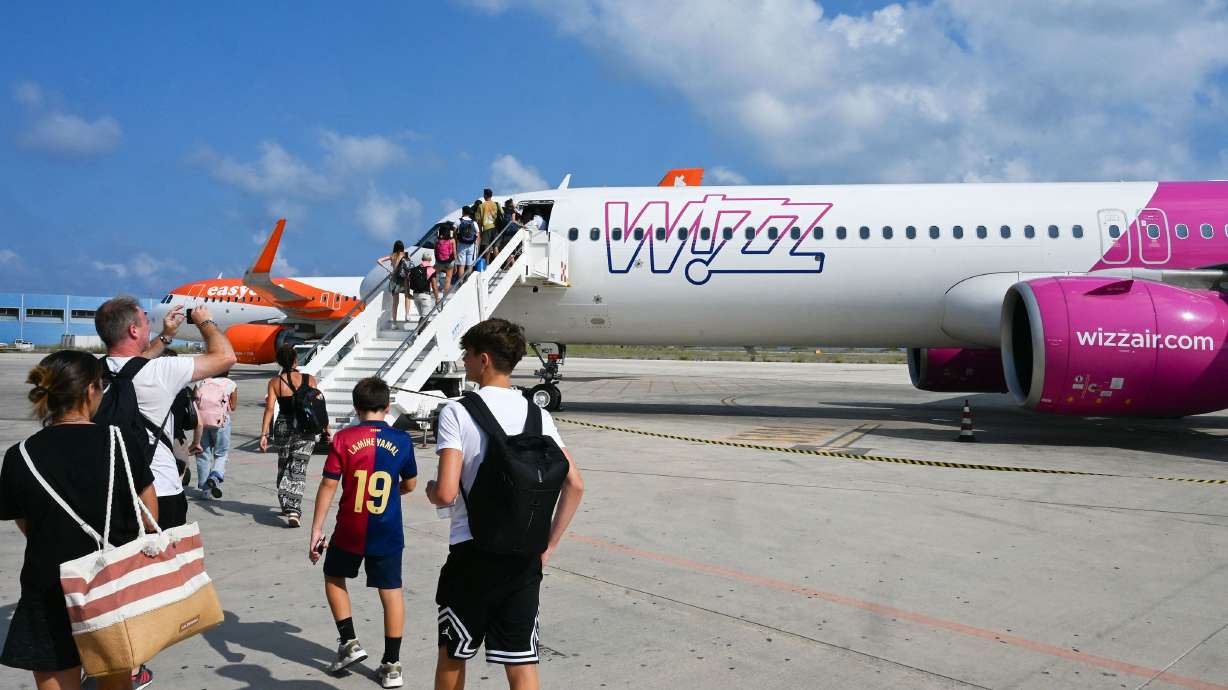 Passengers embark on a Wizz Air jet at Lampedusa Airport on Aug. 17, 2025. The low-cost carrier model, which works well in Europe, has struggled to succeed in the U.S.