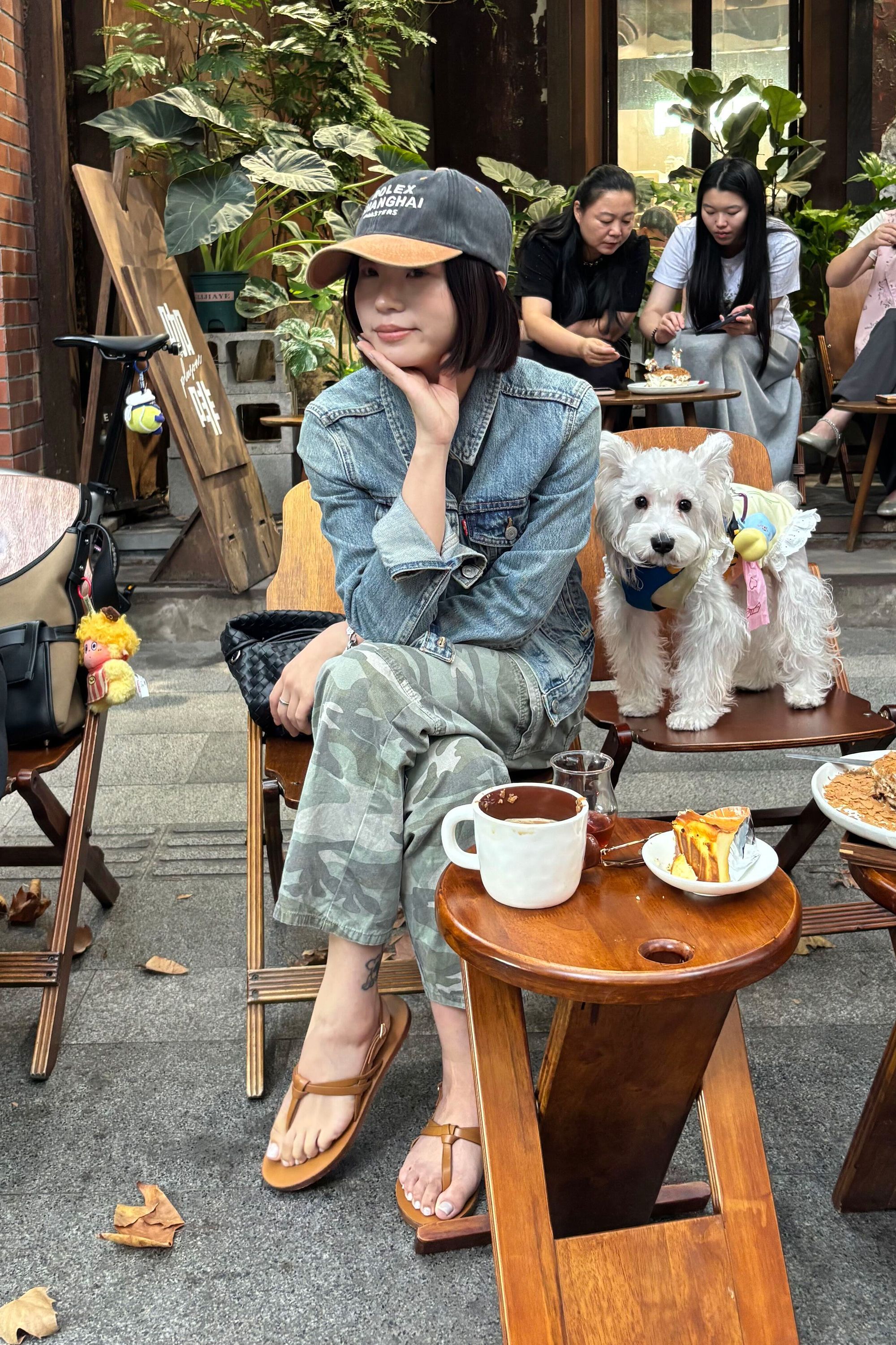 Ma Xue Li people watches from a cafe in the former French quarter. After having a coffee, she will shop the tranquil area's many boutiques.